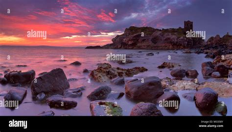 Spectacular sunrise at Kinbane Head with the ruins of Kinbane Castle on the Causeway Coast in ...