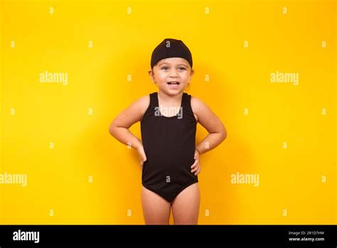 Little girl wearing beach outfit on yellow background. Summer and ...