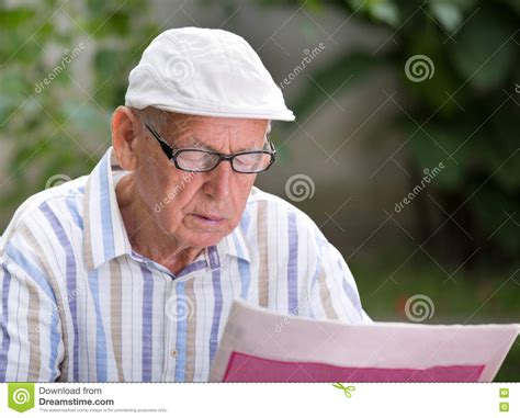 Old man reading newspaper stock photo. Image of news - 77983104