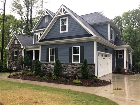 a house with blue siding and white trim on the front door, windows, and ...