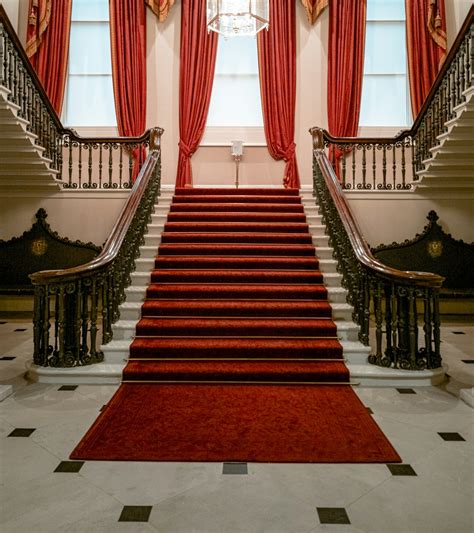 inside building with red carpet on stairs photo – Free Staircase Image on Unsplash