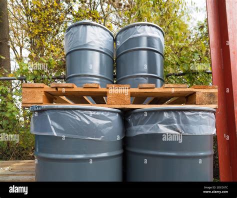 storage of empty oil barrels at a factory Stock Photo - Alamy