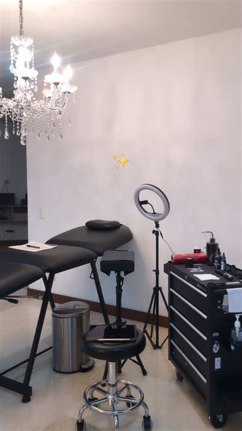 a hair salon with chairs and lights in the corner, chandelier hanging ...