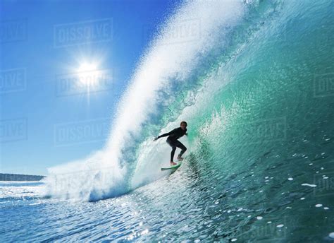 Surfer On Blue Ocean Wave - Stock Photo - Dissolve