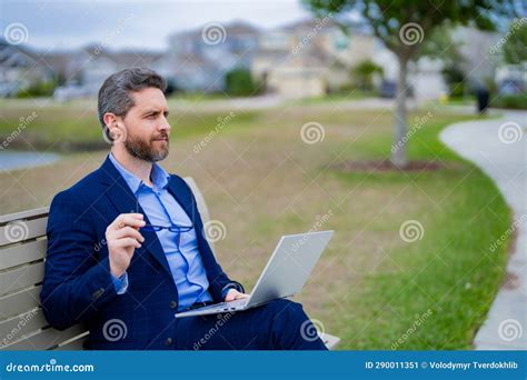 Business Man in Suit Sitting on Bench. Business Man on Bench in Park Outdoors. Thinking about ...