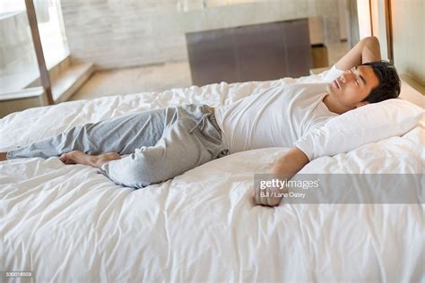 Young Man Sleeping On Bed High-Res Stock Photo - Getty Images