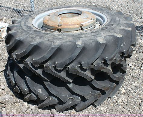 (2) Goodyear 14.9-28 tractor tires and wheels in Hesston, KS | Item B9857 sold | Purple Wave