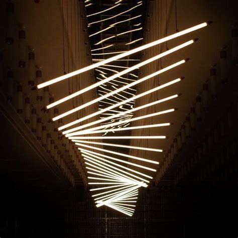an artistic light installation in the middle of a room with lights hanging from it's ceiling