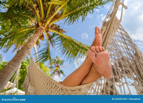 Relaxing Beach Vacation with Woman`s Feet in Hammock between Coconut ...