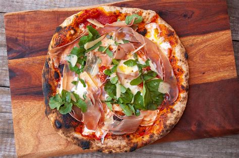 Looking to change up pizza night? This prosciutto pizza with burrata and arugula is a ...