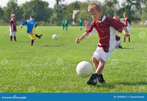 Boy kicking football stock image. Image of green, hunt - 19204517