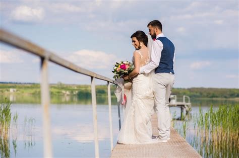 Premium Photo | Beautiful wedding couple hugging on bringe