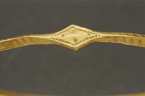 Viking gold arm ring. Found at Hässleberga, Sweden. The Swedish History Museum. (Another view ...