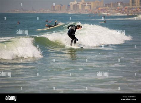 Surfing waves of Far Rockaway Beach on a very hot day of June Far Rockaway Beach Queens New York ...