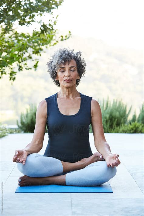 "Senior Woman Doing Yoga And Meditation At Home" by Stocksy Contributor "Trinette Reed" - Stocksy