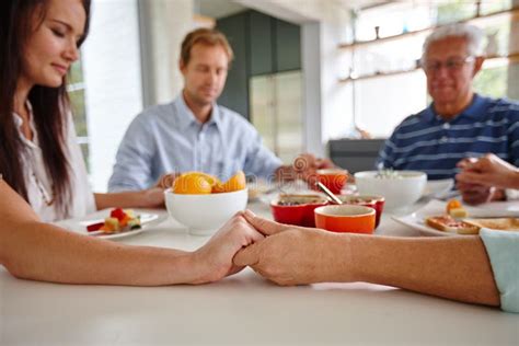 Eat, Pray, Love. a Family Saying a Prayer before Eating Their Food ...