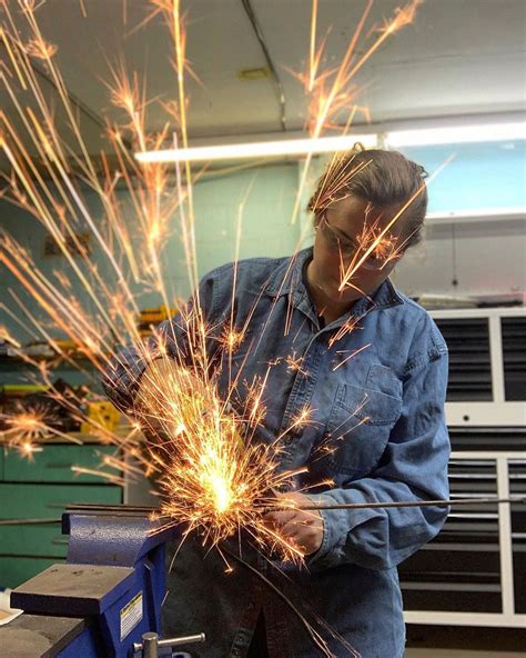 a man working with sparks in a factory