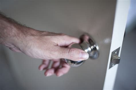 Free Image of Man Hand Holding a Knob in Opening the Door | Freebie.Photography