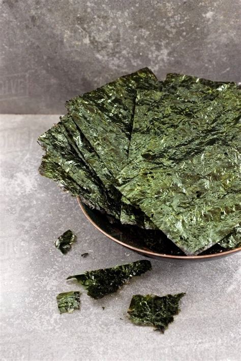 A bowl of seaweed chips - Stock Photo - Dissolve