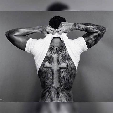 Lewis Hamilton's back tattoo of a cross and angel wings | Hamilton tattoos, Back tattoos for ...