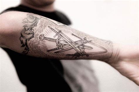 Crossed swords tattoo on the outer forearm by Dogma Noir | Outer forearm tattoo, Sword tattoo ...