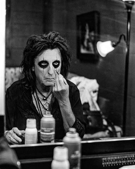 I was trying to find a pic of Alice Cooper applying his makeup to ...