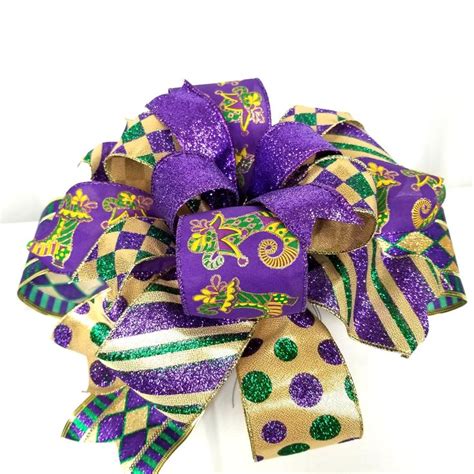 a purple and green hair bow on a white background