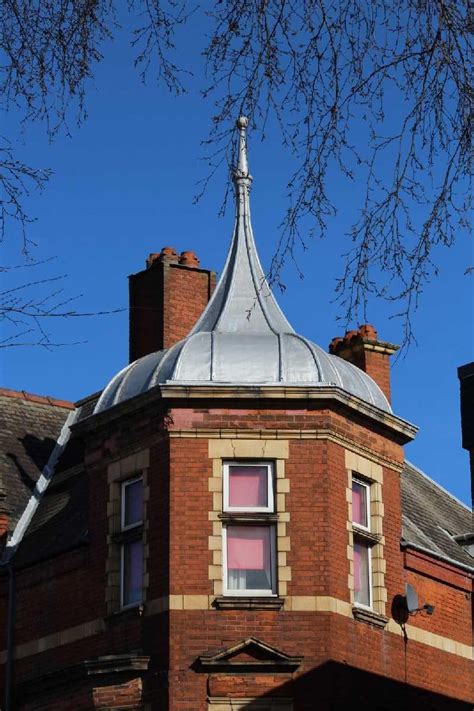 an old brick building with a metal roof