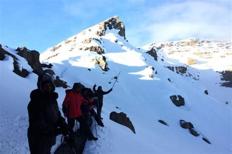 Why is Mount Kilimanjaro covered with snow at the summit?