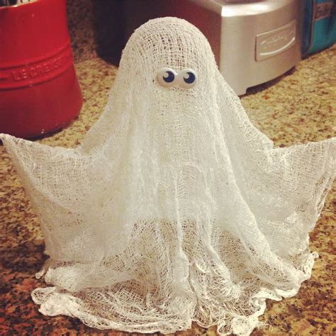 a white plastic ghost sitting on top of a counter