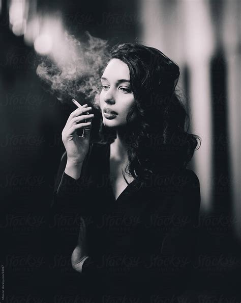 "Beautiful Woman Posing With A Cigarette." by Stocksy Contributor "Mosuno" - Stocksy