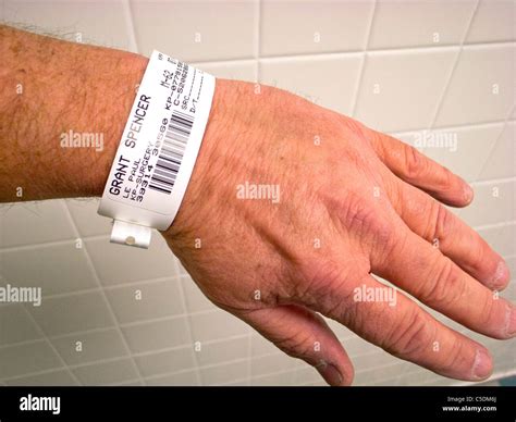 A hospital patient wears an identification wristband complete with ...