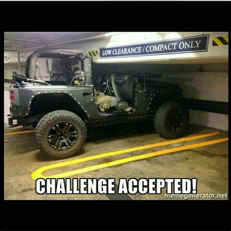 a jeep parked in a parking garage with the words challenge accepted on it's side