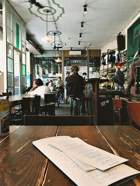 People Sitting on Bar Chairs and Dining Chairs · Free Stock Photo