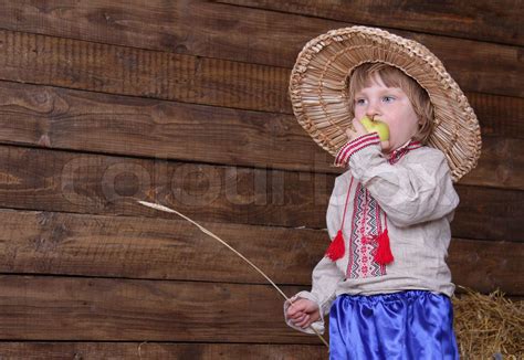 cute child in eastern europe traditional costume in hayloft | Stock ...