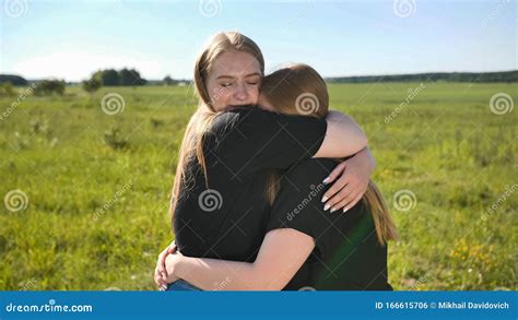 Portrait of Hugging Two Twin Sisters in the Field on a Warm Summer Day Stock Photo - Image of ...