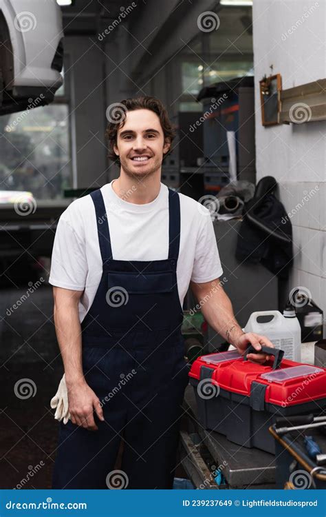 Cheerful Mechanic in Overalls Looking at Stock Image - Image of gloves ...