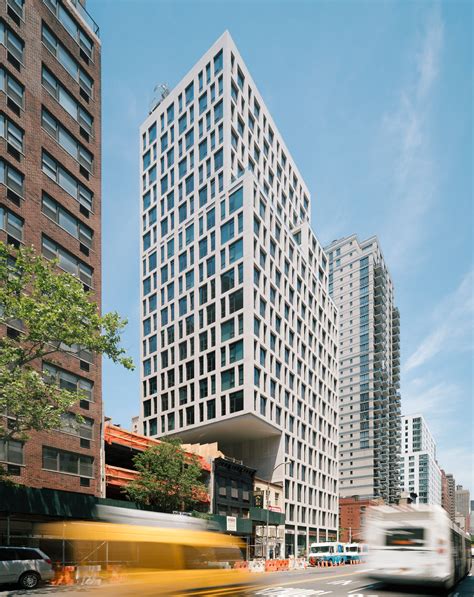 Luxury Manhattan apartment tower by S9 Architecture cantilevers over low-rise neighbour ...