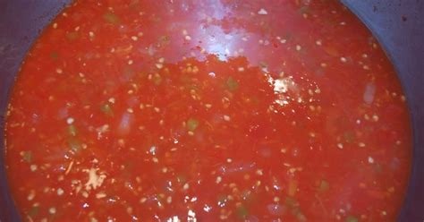 the tomato sauce is being cooked in a pan on the stove top, ready to cook