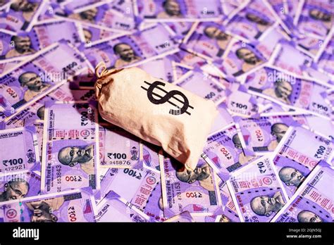 us dollar sign money bag against Indian one hundred rupees background Stock Photo - Alamy