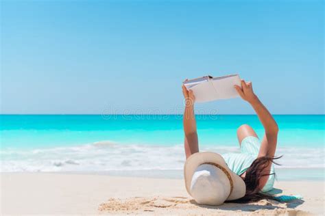 Young Woman Reading A Book Lying On The Beach Stock Photo - Image of bridge, enjoying: 174336376