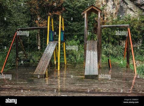 Playground in the rain, Caleta Tortel, Patagonia, Chile Stock Photo - Alamy