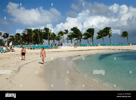 Vacationers walk the beach at Little Stirrup Cay, Bahamas - one of the ...