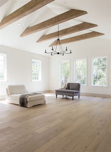 Expansive modern living room with vaulted ceiling and exposed beams ...