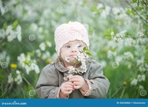 Little Girl with Down Syndrome Smelling Flowers Stock Photo - Image of ...