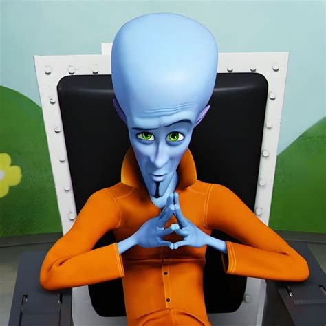 an alien man sitting in front of a computer monitor with his hands ...