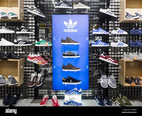 JD Sports store. UK. Adidas tainers/running shoes display Stock Photo ...