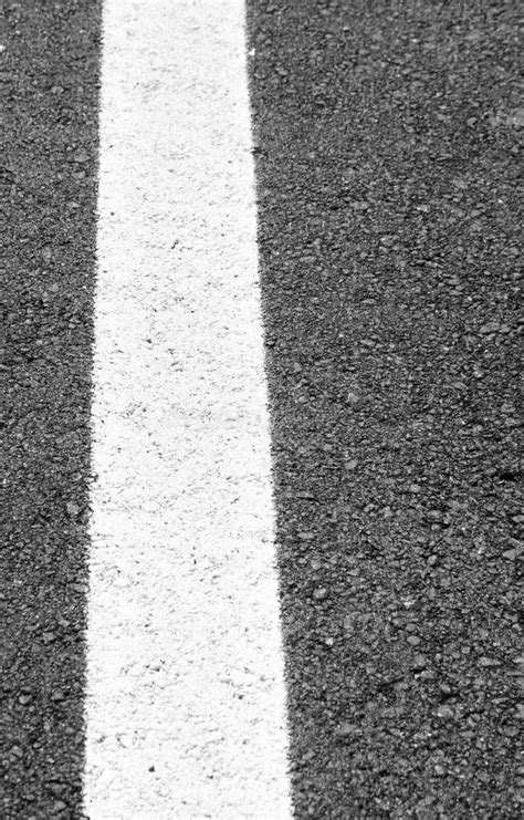 White Line Painted Across the Black Asphalt Road Stock Image - Image of contrast, line: 33504239