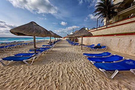 Royalty-Free photo: Umbrellas and lounge chairs on Sunny Beach ...