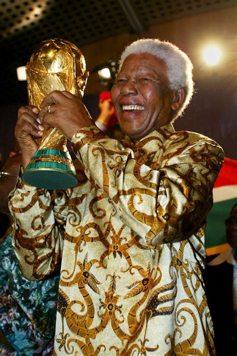 Winning: Nelson Mandela holds aloft the World Cup after FIFA announced that the 2010 World Cup ...